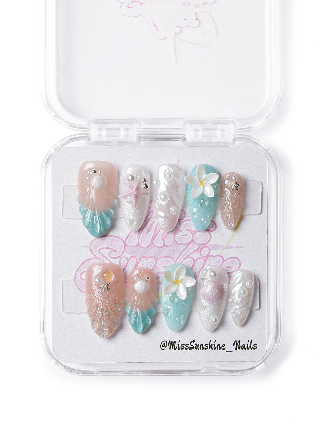 Handmade ocean-themed nails with nude and aqua tones, beach accents, and glossy gel finish