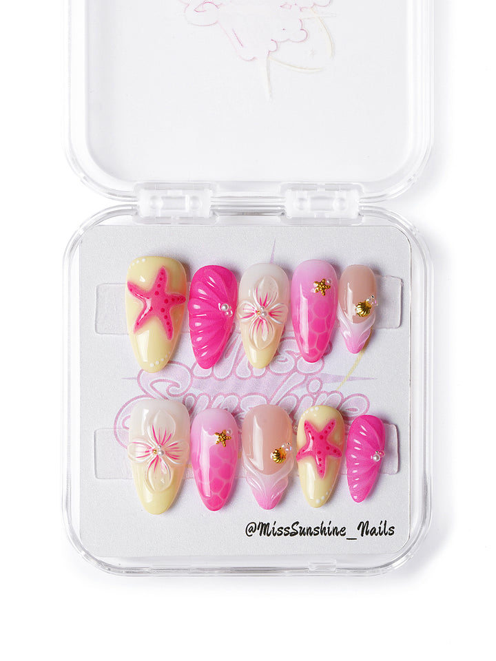 Handmade summer nails featuring pastel pink and yellow ombré with ocean-inspired design