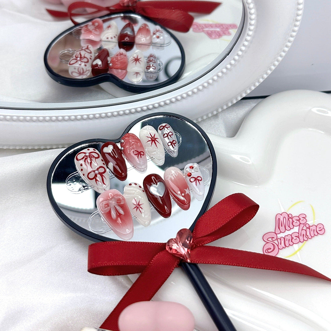Coquette bow press-on nails with red and white ombré