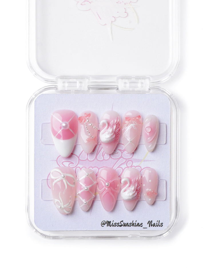 Elegant press-on nails featuring a swan motif, glitter details, and a glossy finish