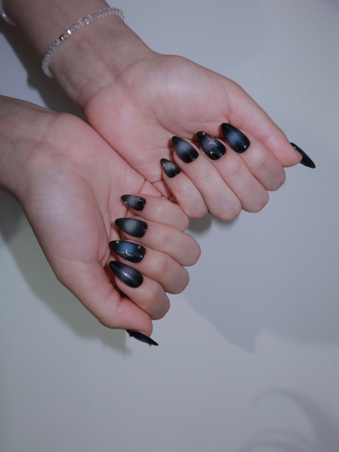 Black purple shimmer nails with gems