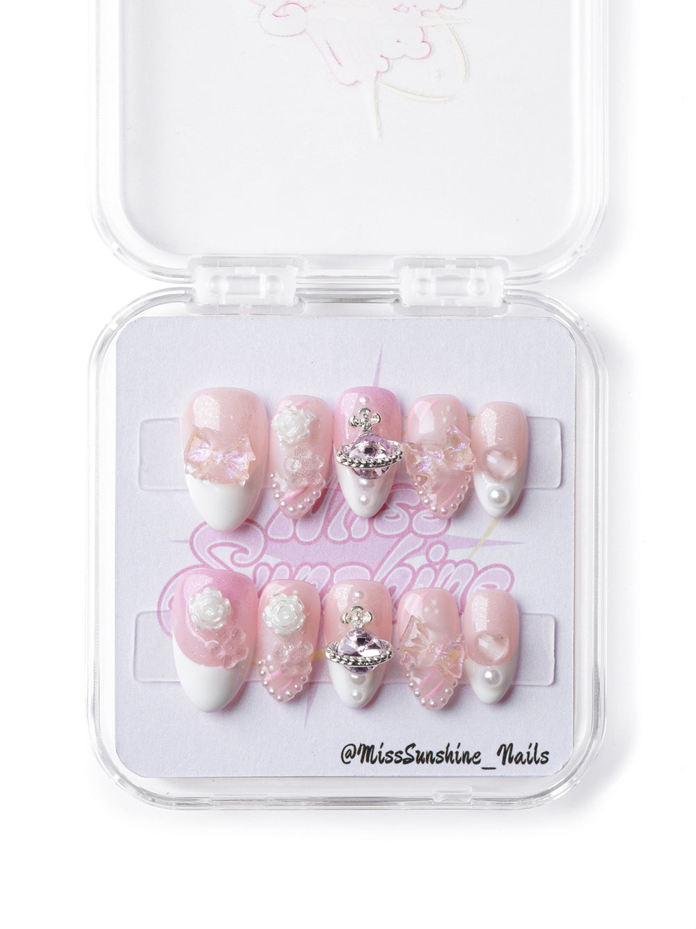 Dreamy pink celestial press-on nails with pearl details, butterfly accents, and a statement planet charm
