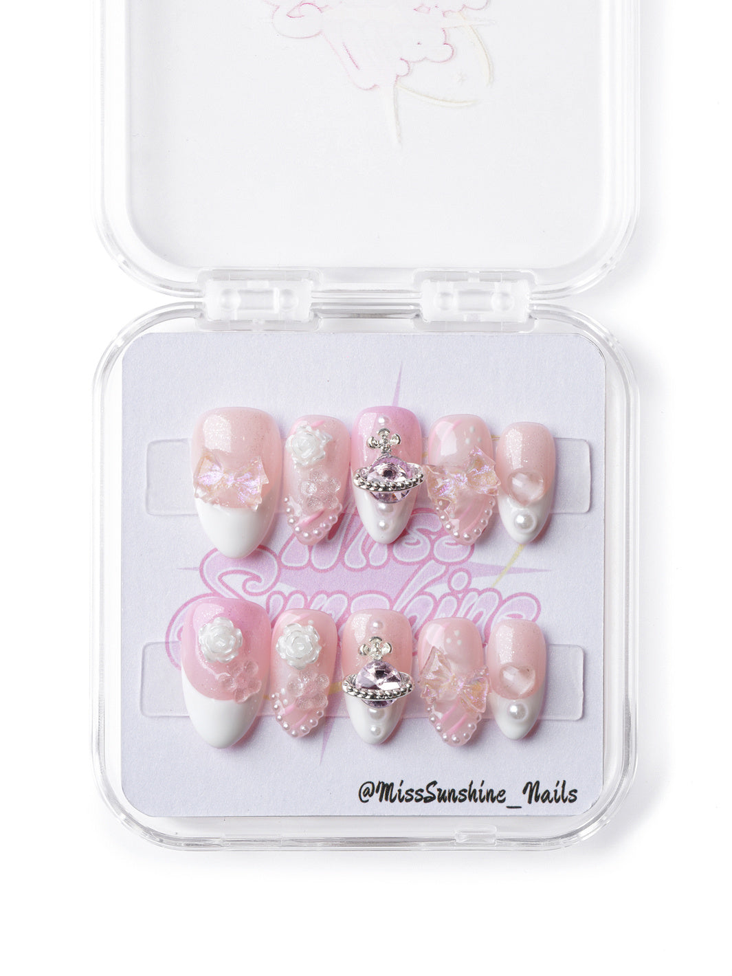 Dreamy pink celestial press-on nails with pearl details, butterfly accents, and a statement planet charm