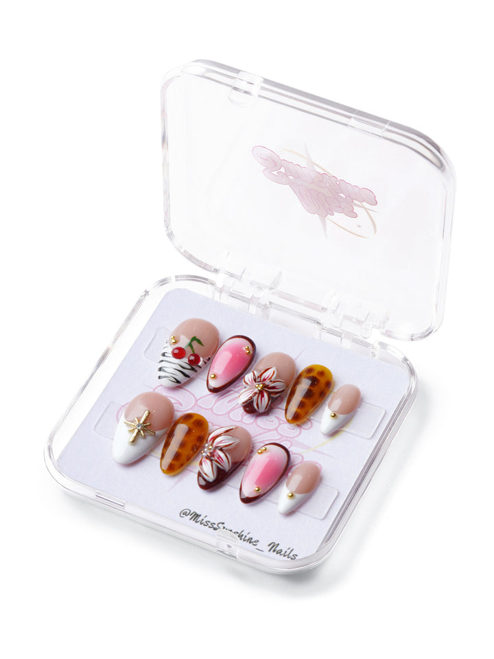 Floral Baddie extra short almond press-on nails with tortoise shell, floral designs, zebra print, and gold embellishments.