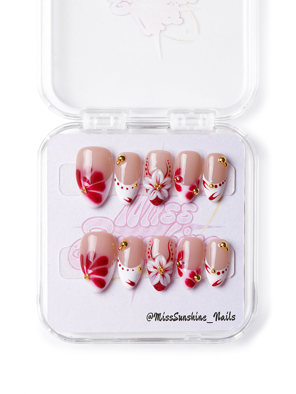 Handmade press-on nails with bold red petals and soft nude base for a chic everyday look