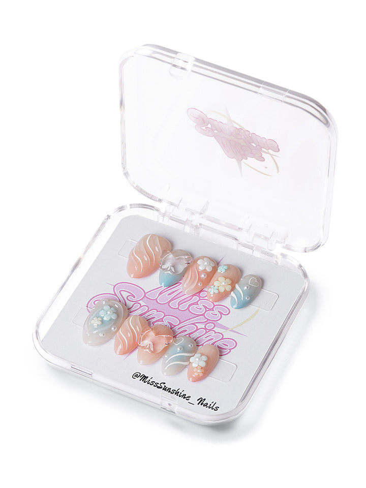 Extra short almond nails in pastel tones with floral 3D accents