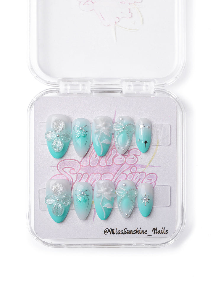 Handmade mint green press-on nails with lotus-inspired design and soft floral charm.