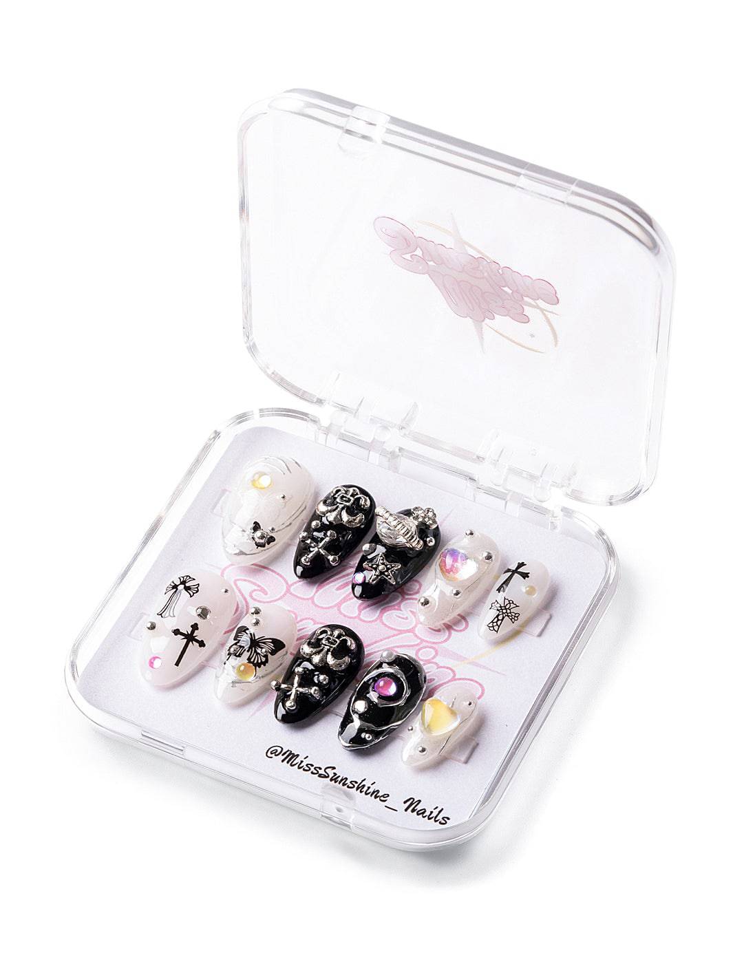 Short almond nails with crosses and celestial charms