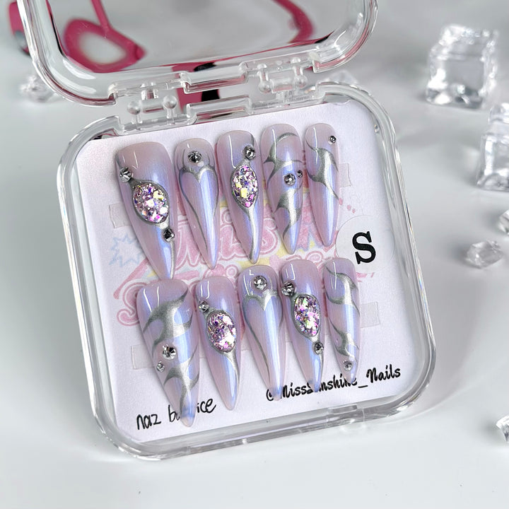 Shimmery lavender nails with coquette flair