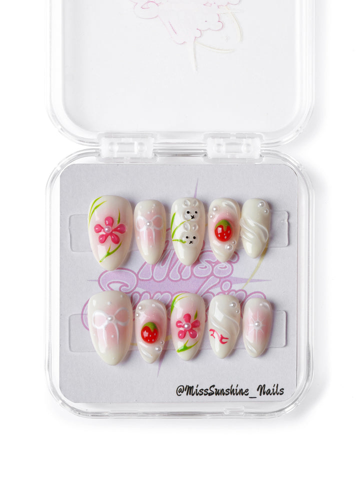 Cute bunny and strawberry nail art on soft pink base