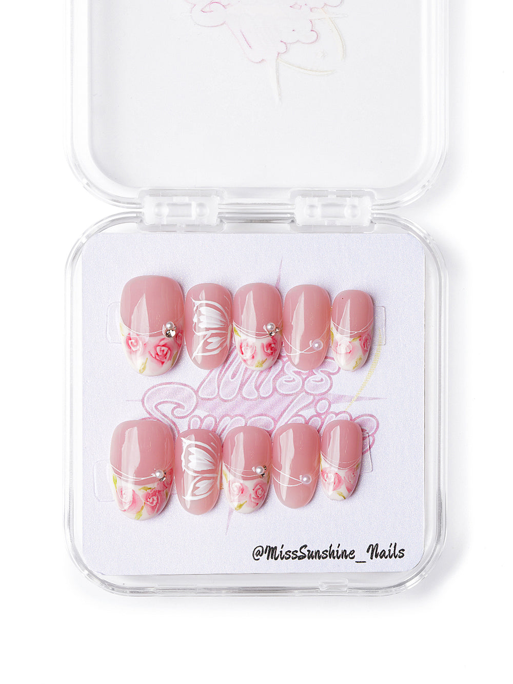 Handmade pink floral nails with butterfly wings and pearls in short oval shape, cottagecore-inspired