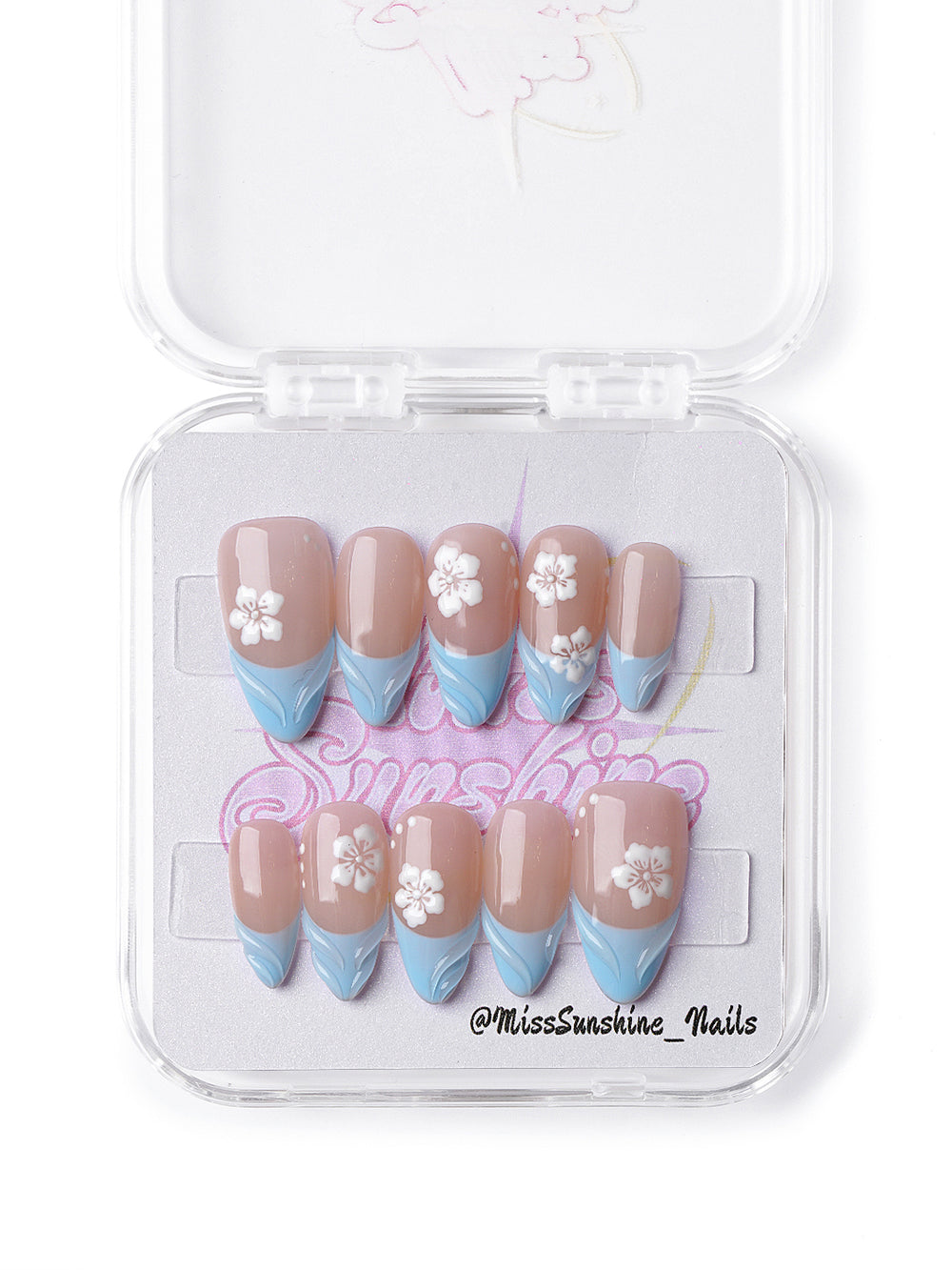 Pastel press-on nails featuring baby blue waves and delicate floral accents.