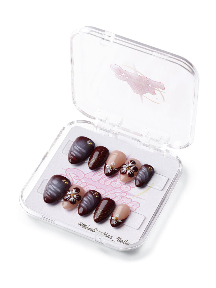 Mocha Petals extra short almond press-on nails with brown and nude tones, floral art, and gold accents.