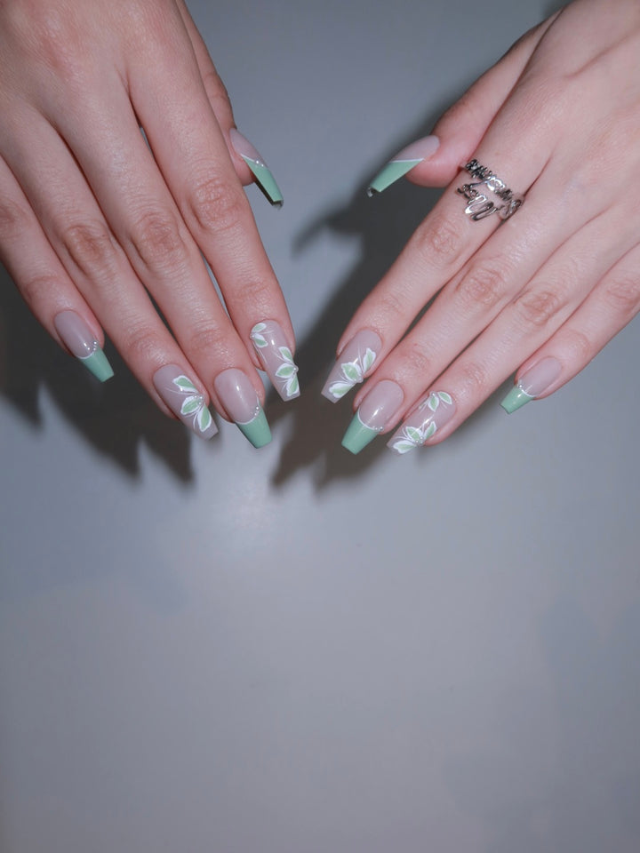 Nature-inspired spring nails with coquette pearl details