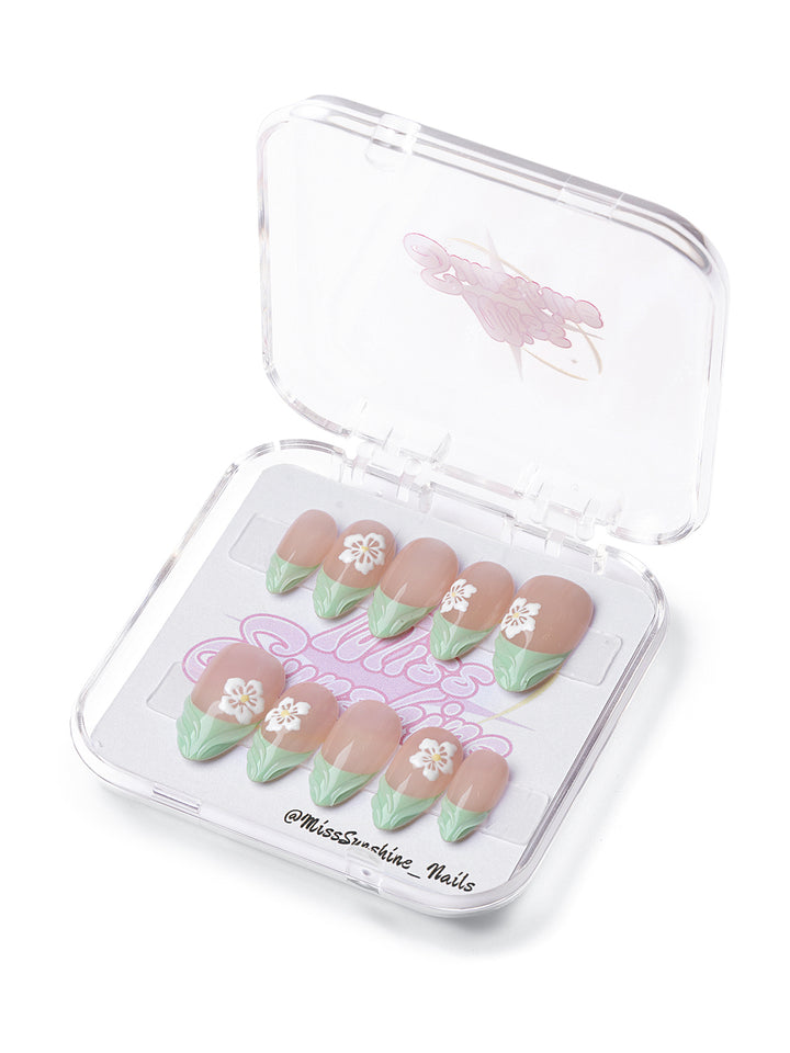 Olive Blossom press-on nails with nude base, sculpted olive green tips, and 3D white floral accents.