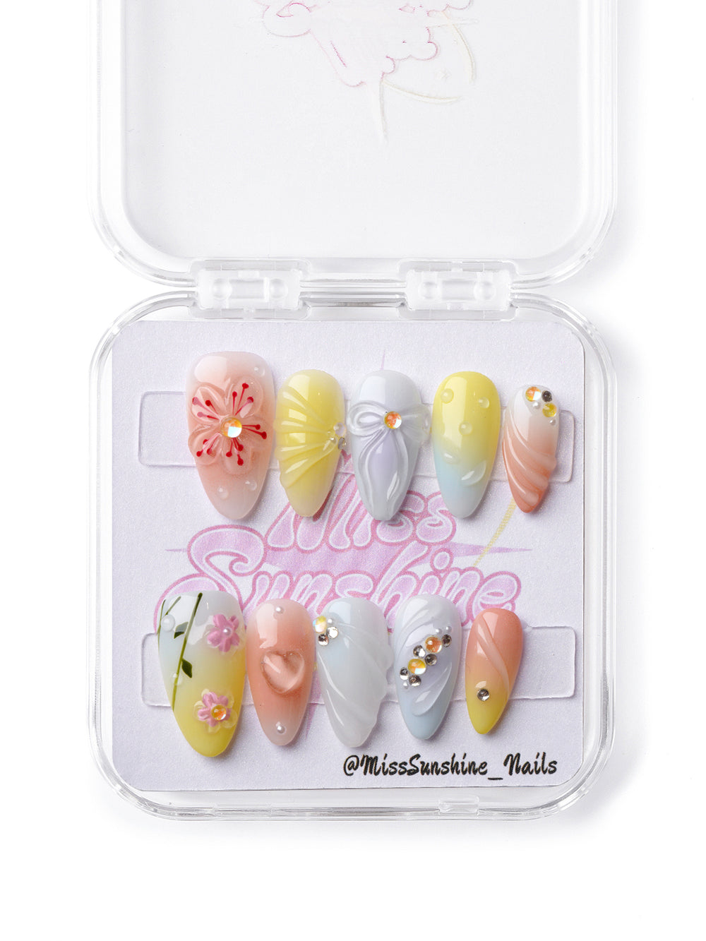 Spring-inspired press-on nails in soft pastels with floral and crystal details for a playful, bright manicure.