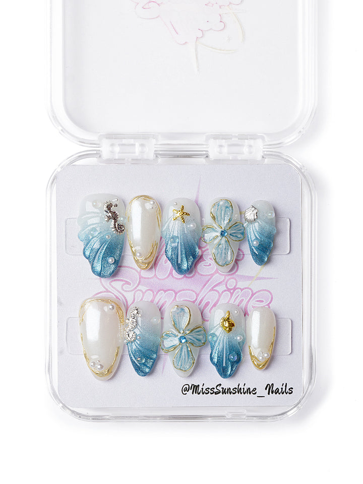 Glittery seashell nails with pearls