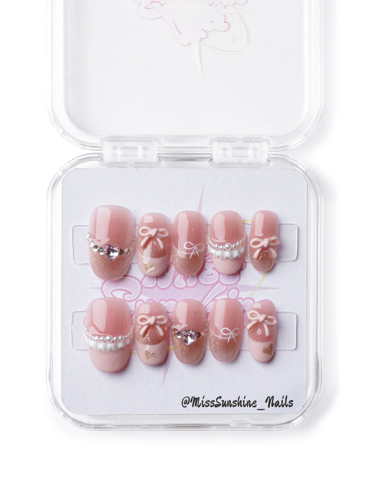 Vintage-inspired nail design featuring delicate lace details, pearls, and sparkling accents