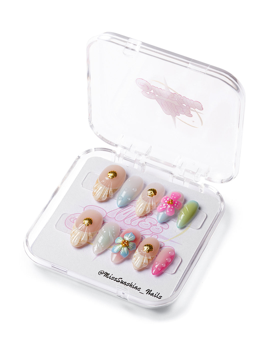 Short almond nails with gold seashell charms, 3D floral art, and pastel leaf textures