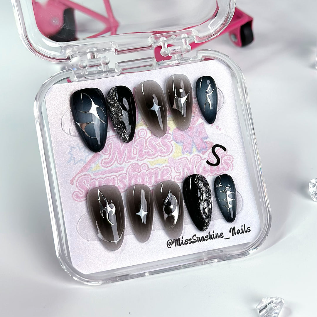 Black and brown ombré nails with star designs