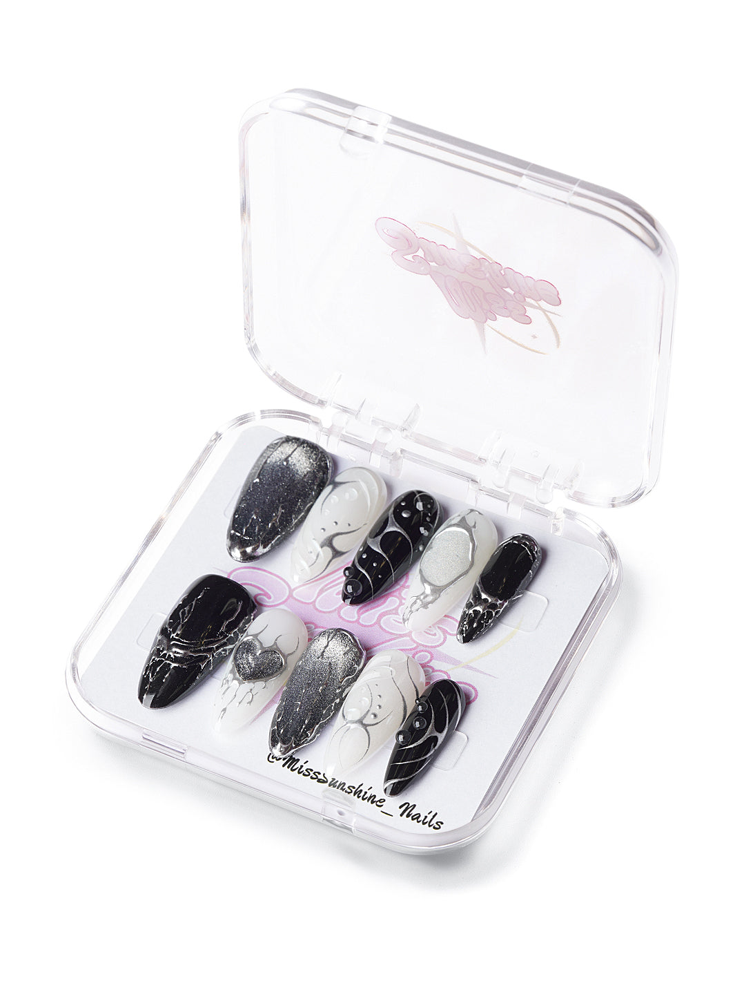 Long almond press-on nails in black and white with chrome lightning and heart designs
