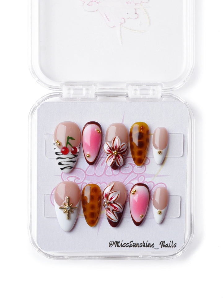 Bold extra short almond press-on nails featuring a mix of pink ombré, zebra print, gold accents, and tortoise shell patterns