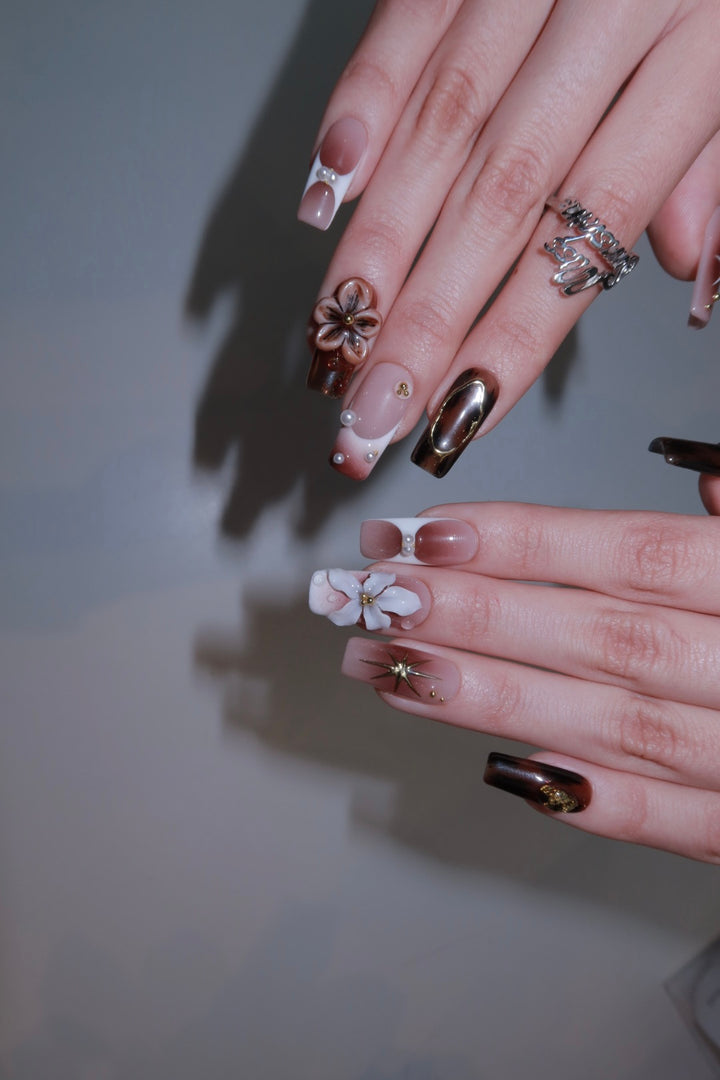 Handmade medium square nails with pearl accents, tortoiseshell details, and sculpted 3D florals.