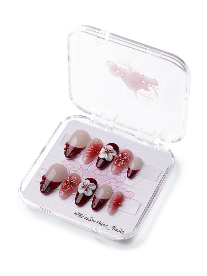 Wine Blossom short almond press-on nails with burgundy tips, 3D flowers, and romantic jelly accents.