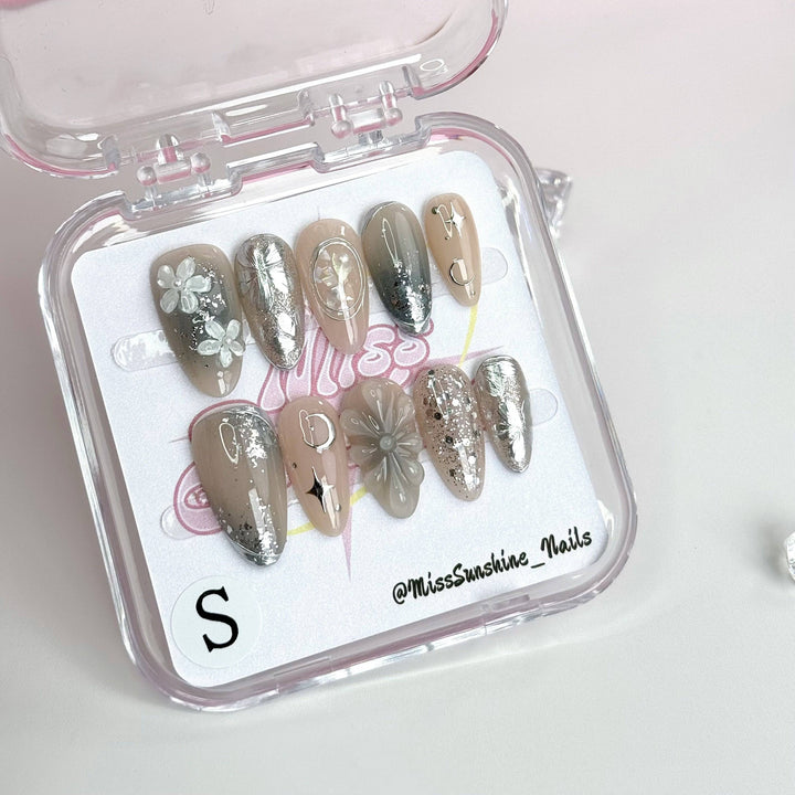Elegant frosty nails with floral and celestial accents