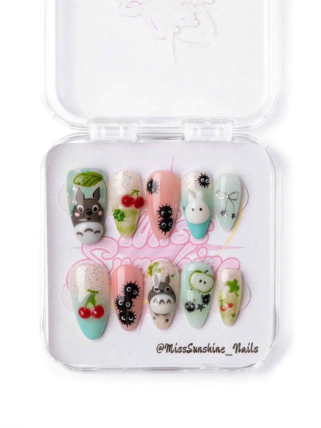Totoro Cherry Garden anime inspired press-on nails with cherries and mint tones
Handmade almond nails with cute character details, clovers, and cherry nail art
Pastel kawaii press-on nails with soot-sprite-inspired accents and forest details
Comic Con inspired anime nails featuring Totoro-style character art and cherries