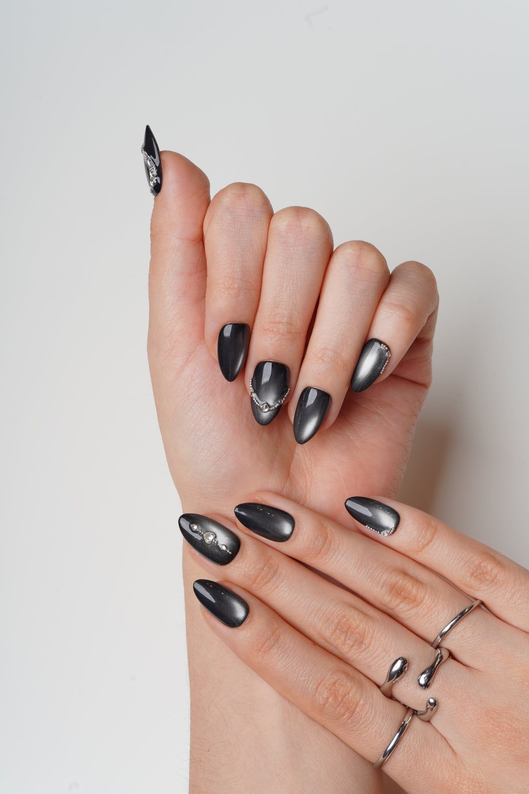 Charcoal cat eye prom nails with statement crystal accent