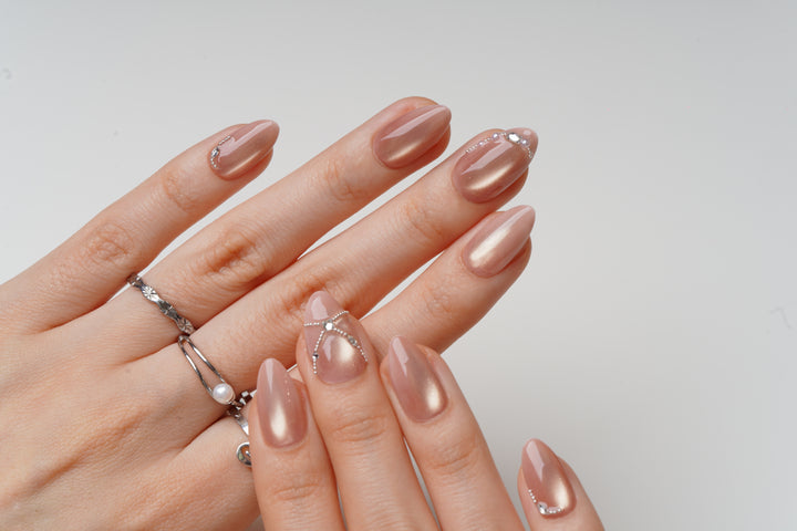 nude cat eye prom nails with subtle crystal accents