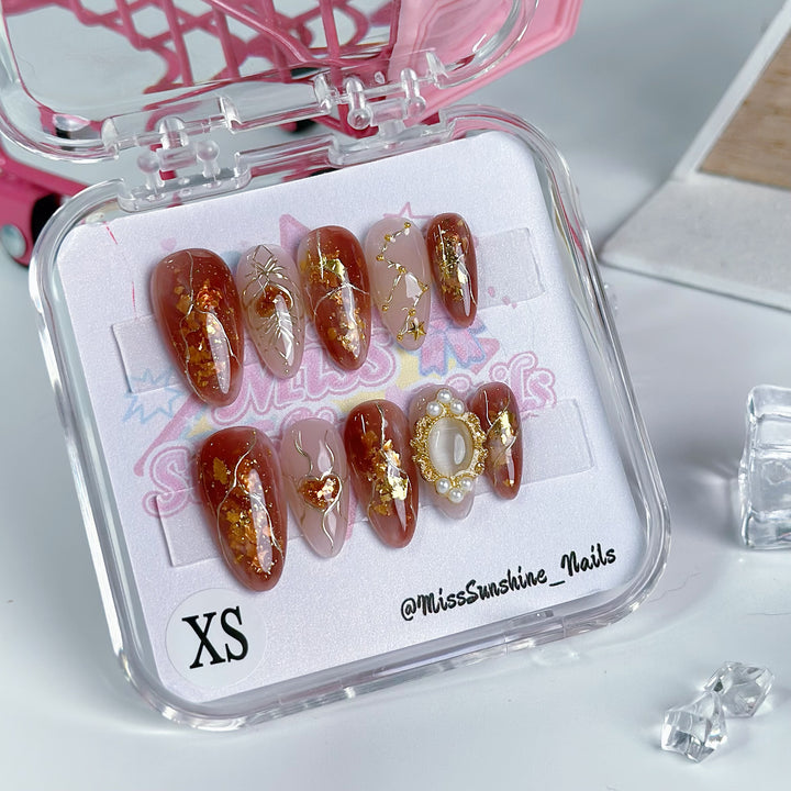 Astrology nails with shimmering red and gold accents