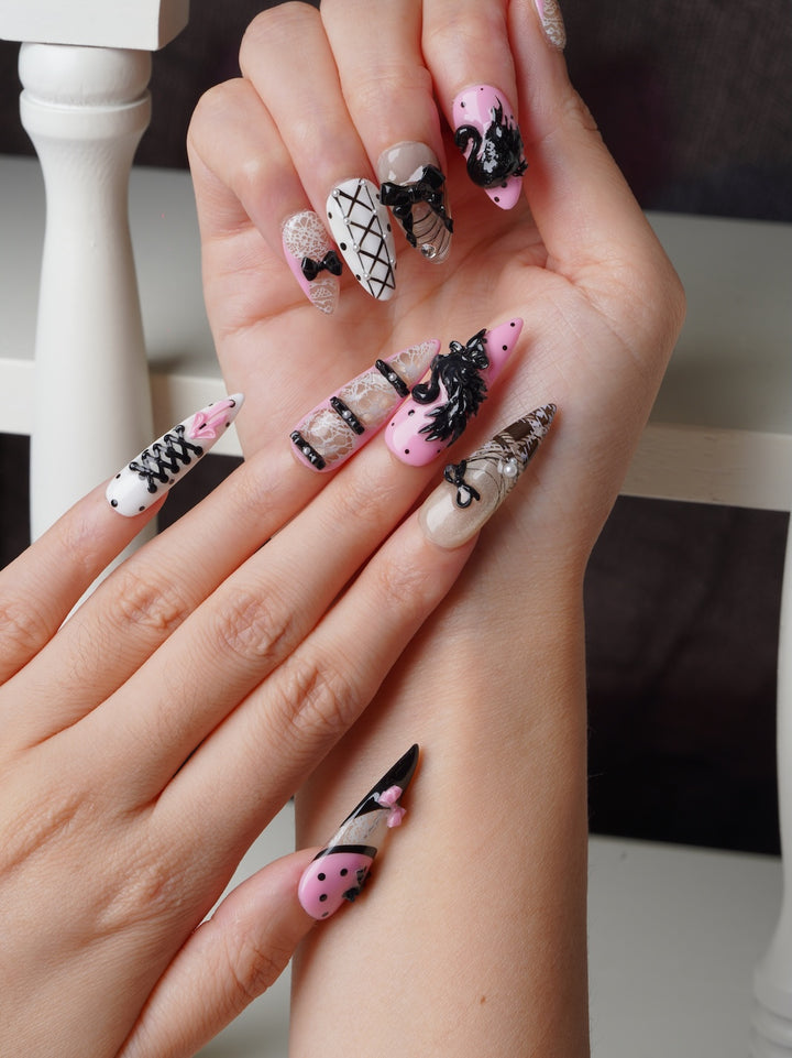 Elegant stiletto nails with 3D swan and delicate lace patterns