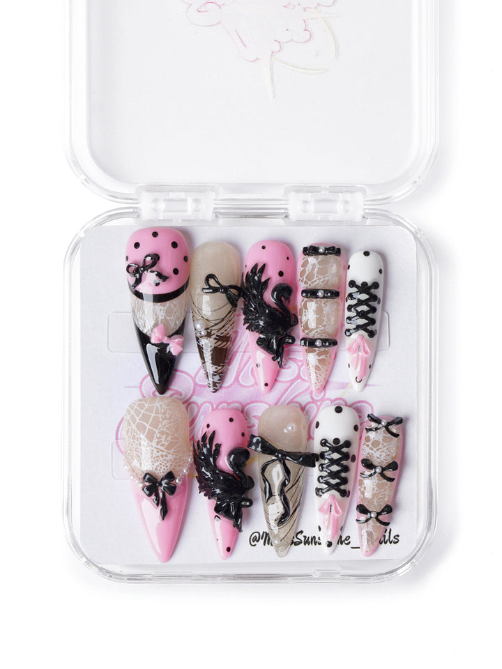 Ballet-inspired press-on nails with pink and black corset details