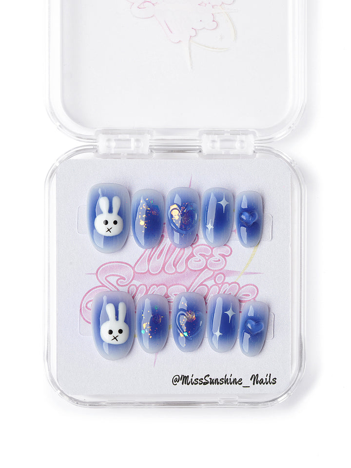 Cute blue press ons with bunny art, star decals, and iridescent glitter details