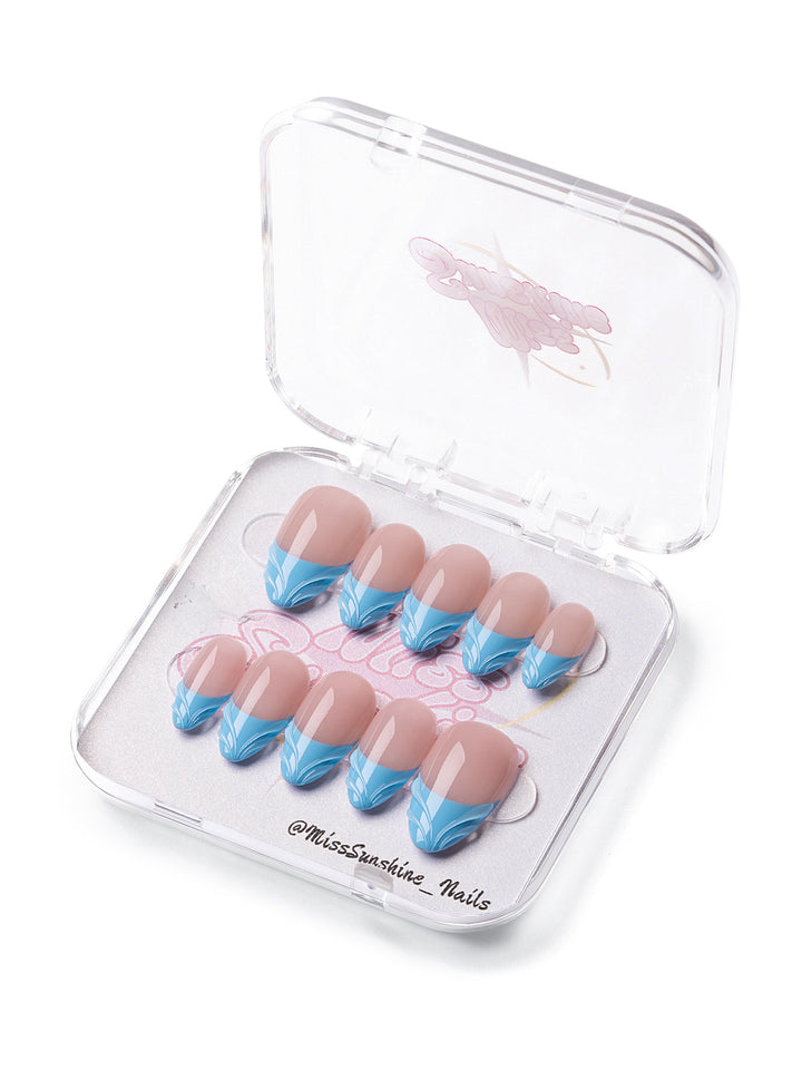 Short almond nails with blue wave French tips in clear case