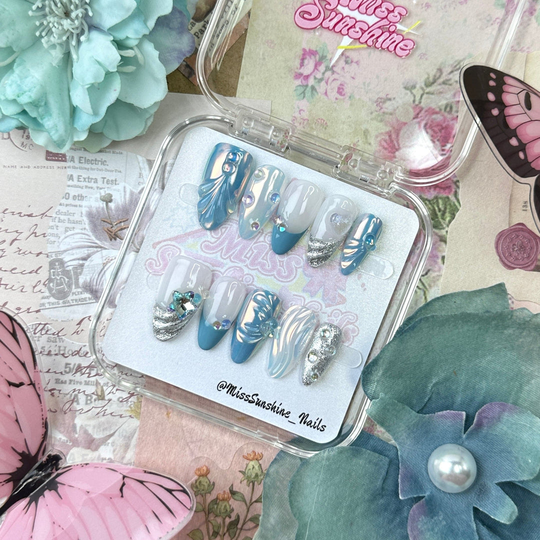 Short almond nails with chrome blue wave accents