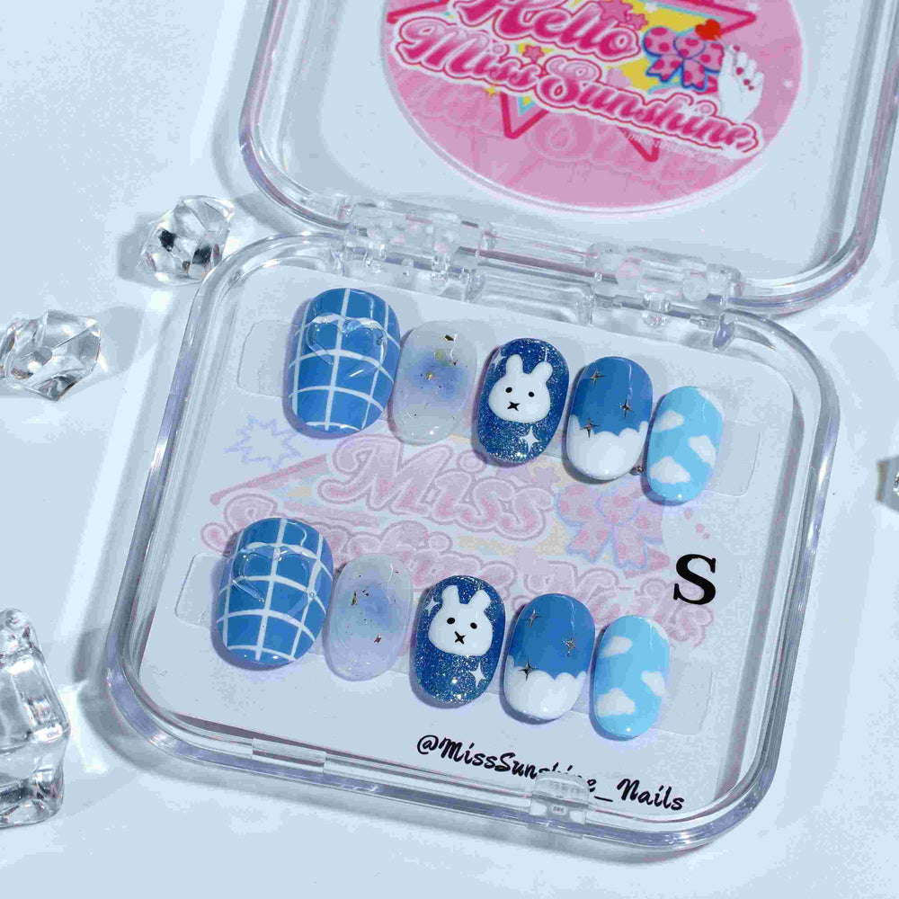 Short oval nails featuring white grid accents