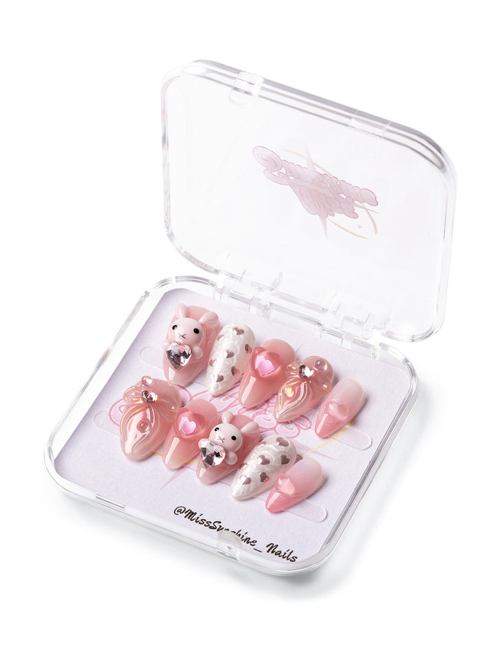 Bunny Love press-on nails featuring soft pink tones, glitter hearts, and 3D bunny charm, perfect for Valentine’s Day.