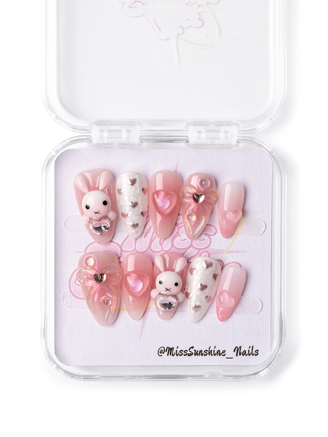 Valentine’s Day press-on nails with 3D bunny, glitter accents, and heart designs in soft pink and silver.