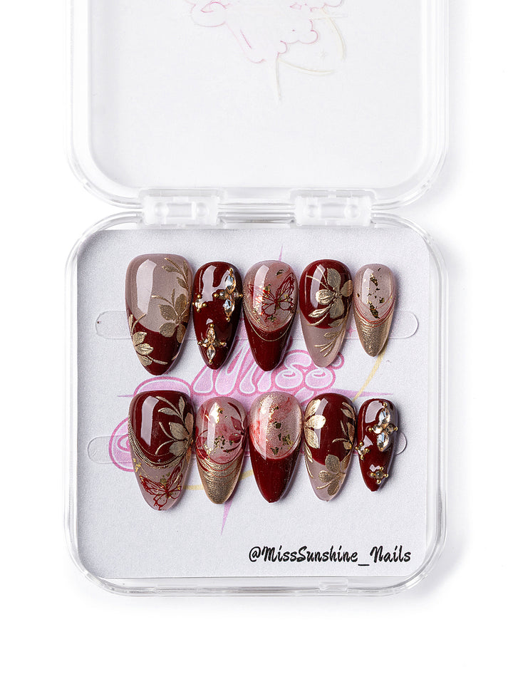 Red Elegance nail set featuring shimmer and flower accents