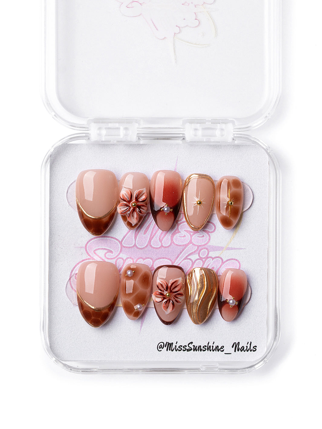 Handmade caramel and nude New Year nails with pearl and floral accents