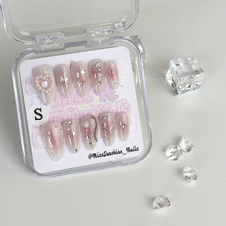 Soft glam nails with cute icons and shimmer