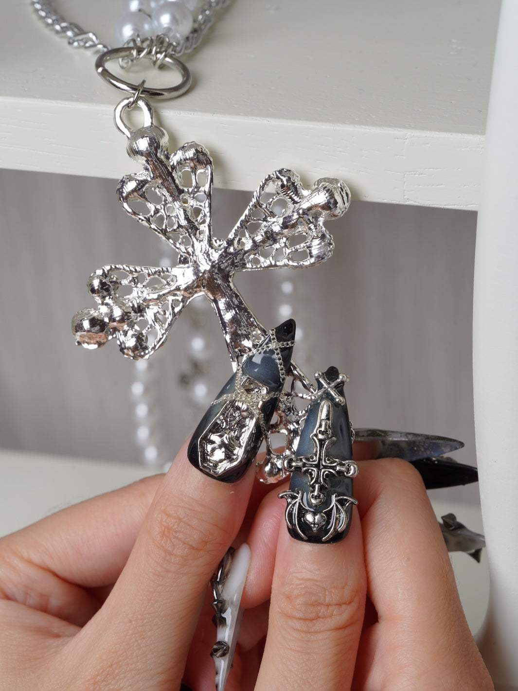 Chained Curse nails featuring metallic crosses and skeleton art
