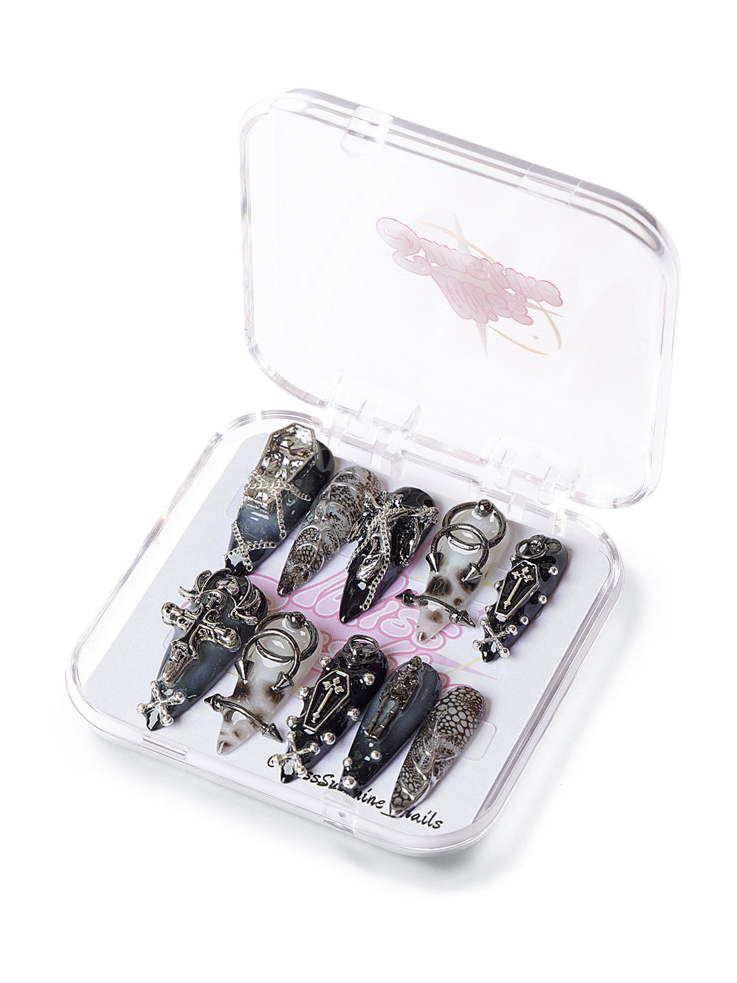 Long stiletto press-on nails with crosses, chains, and coffin accents
