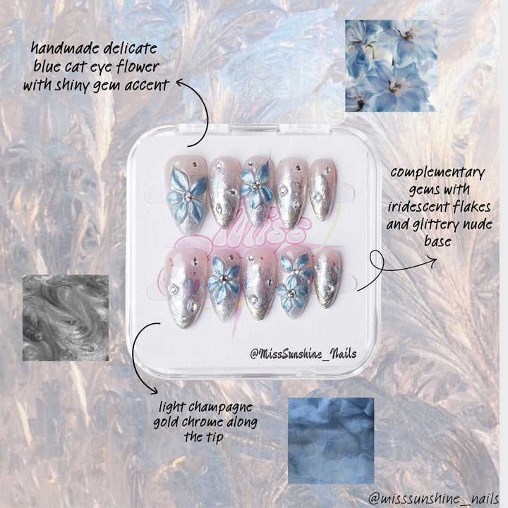 Champagne pink and silver nails with icy blue petal designs and crystals