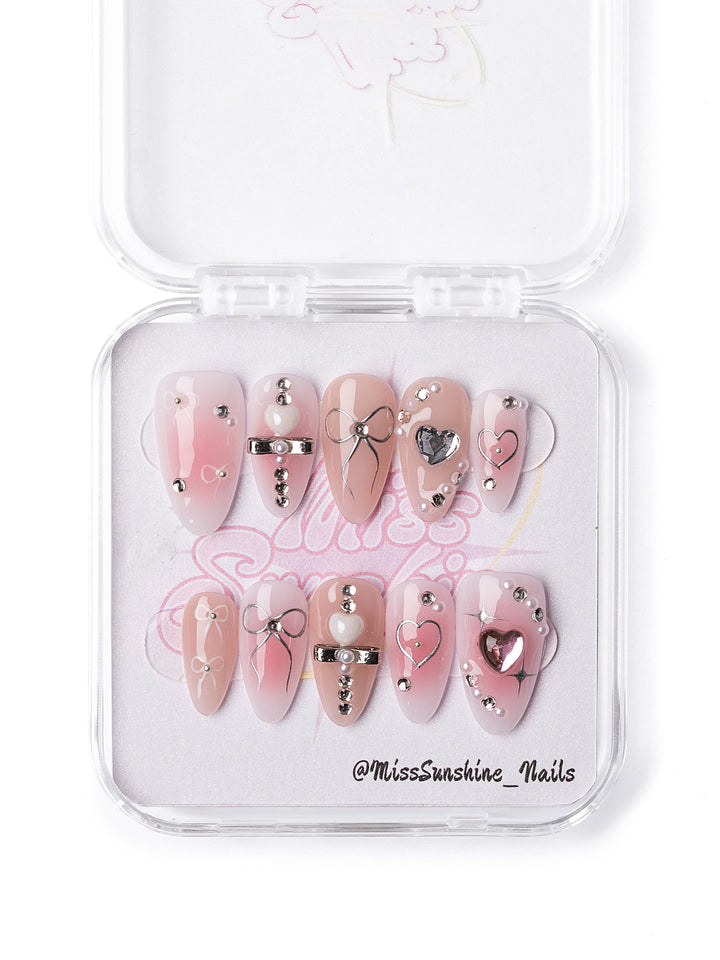 Y2K style press-on nails featuring silver heart charms