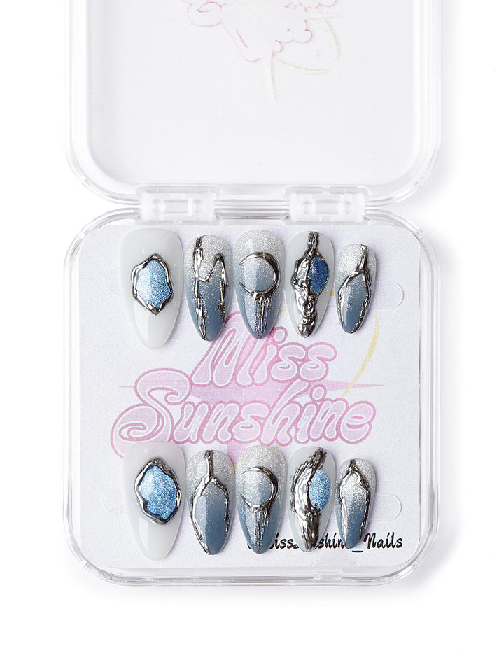 Handmade winter nail set with 3D metallic accents, silver shimmer, and frozen celestial designs