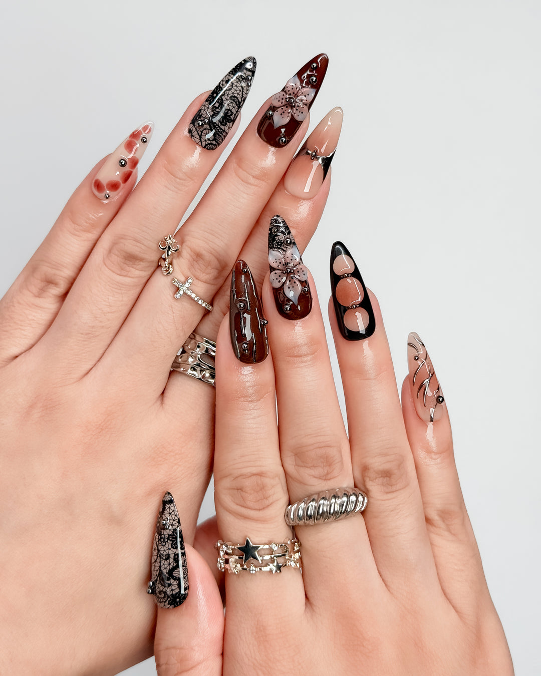 Warm brown press-on nails with vintage lace-inspired floral nail art